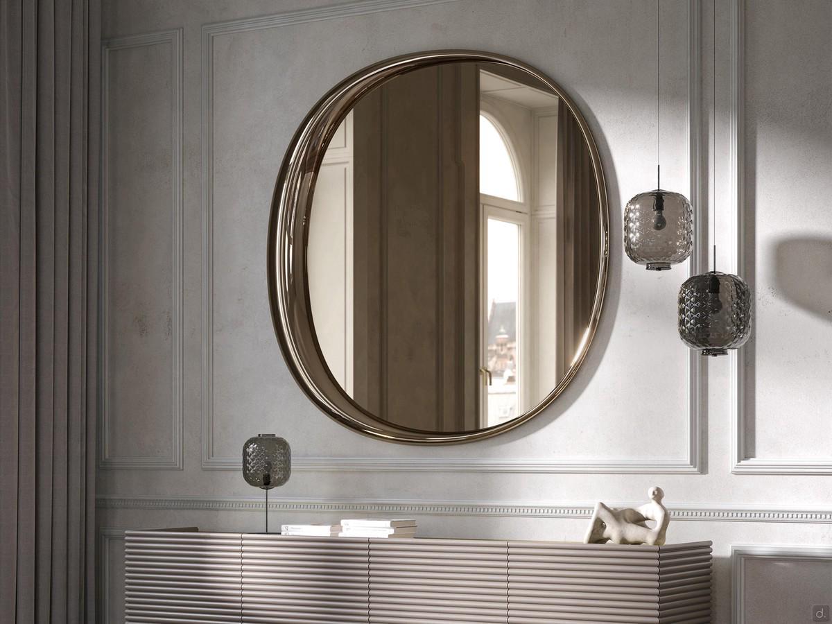 Genesi mirror in bronze finish contextualised within a composition with sideboard