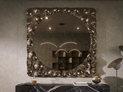 Composition featuring a sideboard paired with the Fluid mirror in its square format with a bronzed finish.