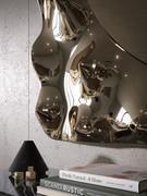 Detail of the reflective frame in fused glass and its characteristic undulating effect that reflects and reshapes the surrounding space