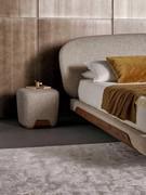 Square pouf for the Olos bedroom by Bonaldo with the bed of the same name, with which it shares a wooden base