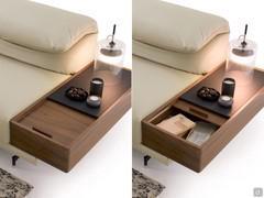 Detail of the wooden storage armrest with internal compartment and leather top