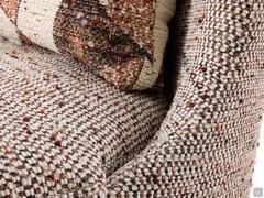 Detail of the connection between curved backrest and generously padded seat cushion