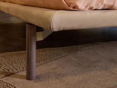 Detail of the bed frame stitching and the wooden foot of the Cayman outlet bed