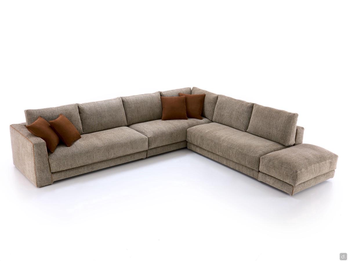 Clive outlet corner sofa with end element with armrest at one end and ottoman at the other end.