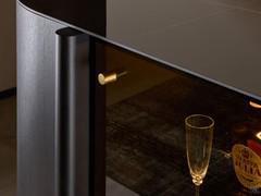 Detail of brass knob on central glass door and ceramic top