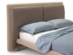 Detail of the double, wide upholstered headboard with attached cushions