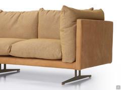 Detail of the elegant tone-on-tone combination of the leather frame that shells the fabric-covered cushions