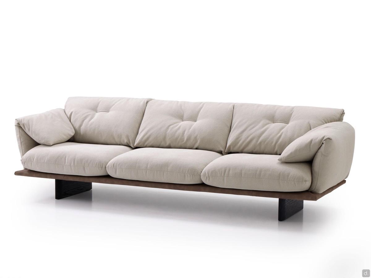 Two-tone Norman outlet linear sofa with precious contrasting embroidery, resting on high wooden feet