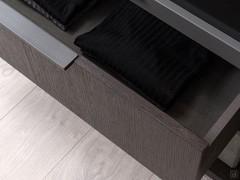 Detail of wooden drawer with mocha shine painted metal handle