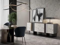 Elegant living room with sideboard Keramos from the blanc de blanc matte ceramic doors. The base with bronze-painted metal plates is coordinated with the sculptural bases of the Zentrum dining table