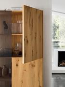 Detail of the Kuba oak hinged door on the Pilar display cabinet, with interior and shelves also made of wood