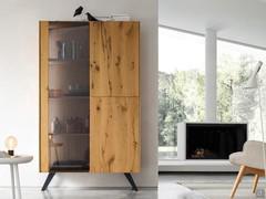 Pilar tall display cabinet with smoked grey glass door and pair of wooden doors to match the frame. Like the sideboard, the showcase also has a customisable base