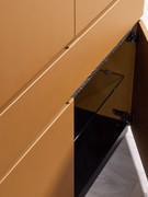 Detail of the hinged compartment of the Raiki sideboard, with central glass shelf