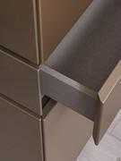 Detail of the central drawer of the Raiki sideboard, with front in the same colour as the structure and interior in jute textured veneer