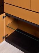 The hinged compartments of the Raiki sideboard are equipped as standard with a central transparent glass shelf for better organisation of interior space