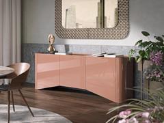 Sally sideboard with rounded edges with glossy lacquered doors and sides, shown in a living context in combination with furnishing accessories from the same collection