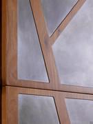Detail of the bi-material wood and metal door, available in numerous colour and texture combinations. Shown here is the oxidised metal decor, with a special antique effect