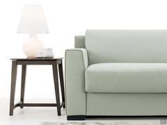 Detail of the flared armrest, the squared wooden foot and the rigorous proportions of the volumes