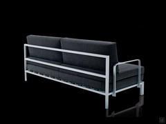 Three-quarter rear view of the convertible sofa bed Willy - detail of the optional armrest and rear metal frame supporting the back cushions