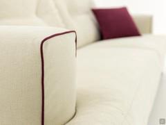 Detail of the armrest edges finished with contrasting piping