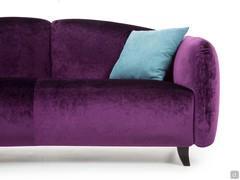 Proportions of one-piece seat high off the ground and upholstered and shaped armrest and backrest