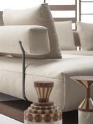 Detail of the upholstered backrest suspended above the seat by the painted metal frame