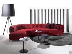 Oban capitonné sofa here proposed with corner peninsula, upholstered in red velvet
