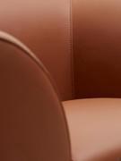 The matching stitching detail shows delicately on the smooth surface of the leather upholstery