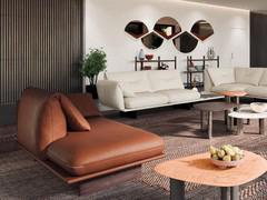 On the left is the freestanding chaise longue. The leather upholstery highlights the contrasting embroidery detail, both on the central part of the back cushion and on the corner of the seat