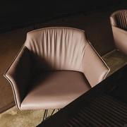 Detail of the upholstered seat with high backrest and armrests