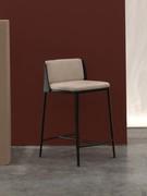 Sangay stool with black metal legs combined with a black leather shell; together they create a pleasant contrast with the light fabric upholstery