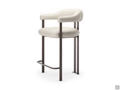 Greta quilted leather stool by Cattelan, with wrap-around armrests integrated into the backrest and metal footrests to match the frame