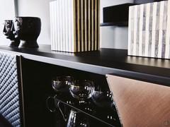 Top in black embossed metallic finish, with doors in black leather and brushed bronze metallic lacquer