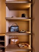 Shelves are here elegantly lit by vertical LED on the sides.
