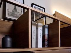 Detail of the suspended open element in lacquered bronze metal and Canaletto walnut wood