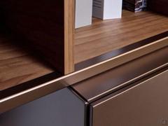 Detail of the 45-degree workmanship of the Freehand wall-mounted storage units and the wood and metal open element on the wall unit