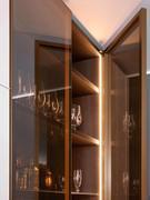 Detail view of Stop Sol bronze glass doors with brass-effect lacquered metal frame