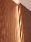 Pair of Lounge boiserie panels mounted with different spacers from the wall: one with technical compartment and one, further away from the wall, with possibility of TV mounting and installation of vertical LED bars on the sides