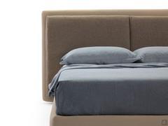 Détail de la tête de lit double et large avec coussins attachés
