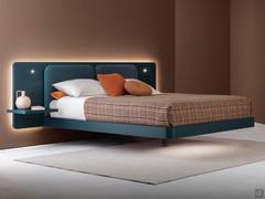 Lit suspendu Master avec longue tête de lit, dans la version avec grande tête de lit et coussins rembourrés assortis. Le cadre et la tête de lit sont laqués mat Night Blue.