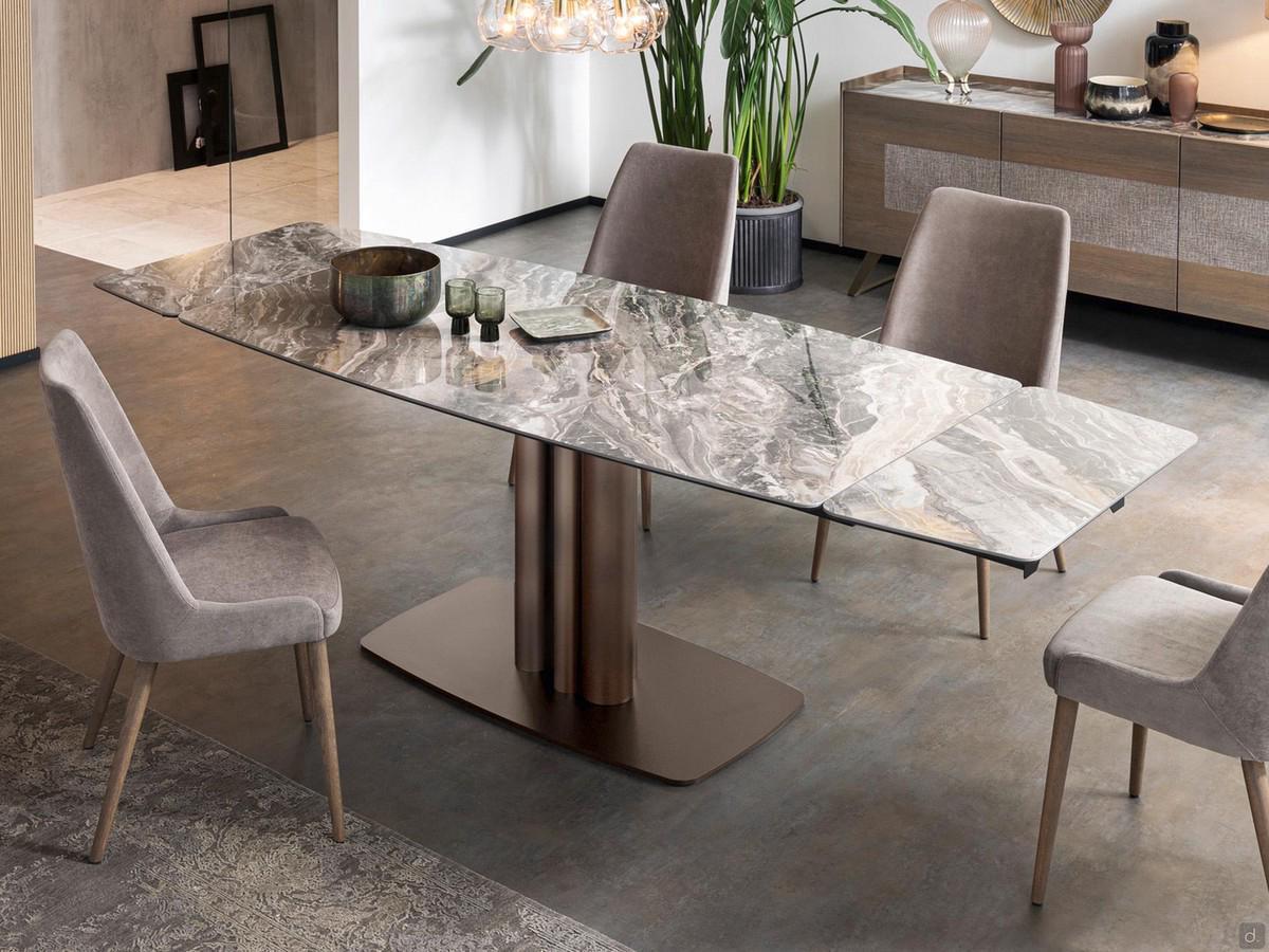 Table avec base centrale en tube d'acier Bahia en version tonneau extensible avec plateau en céramique polie Orobico Lux