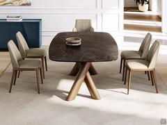 Vue de côté de la table Palladium révélant le cadre en bois massif distinctif avec des pieds croisés, disponible en différentes couleurs.