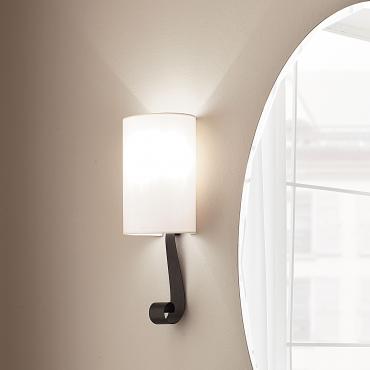 Lampe applique Yole en fer avec abat-jour elliptique en lin avec un ornement en forme de boucle dans la partie inférieure.