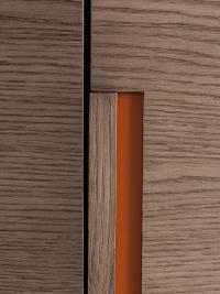 Détails de la poignée en chêne argile avec fond laqué mat cuir (photographie prise sur une armoire battante)