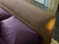 Tête de lit rembouré et moelleuse, avec revêtement en simili cuir vintage, embelli par des coutures en relief en teinte