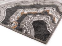 Dettaglio dell'angolo del tappeto Gabrielle da cui parte il motivo che si ispira alle venature del marmo e delle pietre preziose