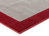 Particolare della cornice rossa termosaladata al tappeto tinta unita