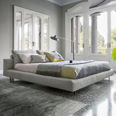 Owen minimal quilted platform bed by Bonaldo with cushioned headboard with low structural support and parallelepiped supportive upholstered elements