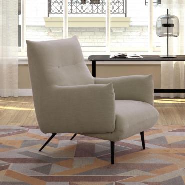 Tangeri armchair characterised by tall, slender metal feet and upholstered volumes covered in fabric, leatherette, velvet or leather