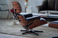 The Eames armchair, a replica inspired by Charles Eames’ design, is available in either wood or leather